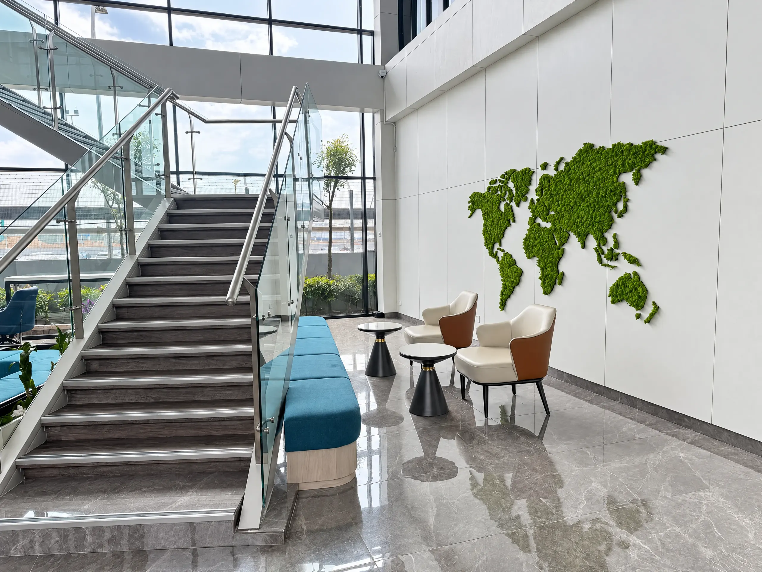 Princeton Digital Group office with feature staircase, moss world-map wall and lounge seating