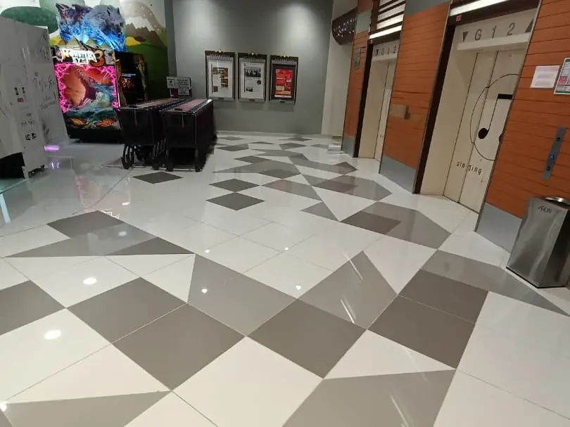Geometric grey-and-white floor tiling in a shopping mall