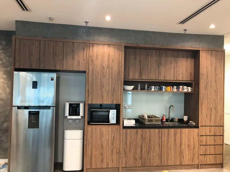 Completed kitchen/pantry with wood-grain cabinets, built-in fridge and appliances