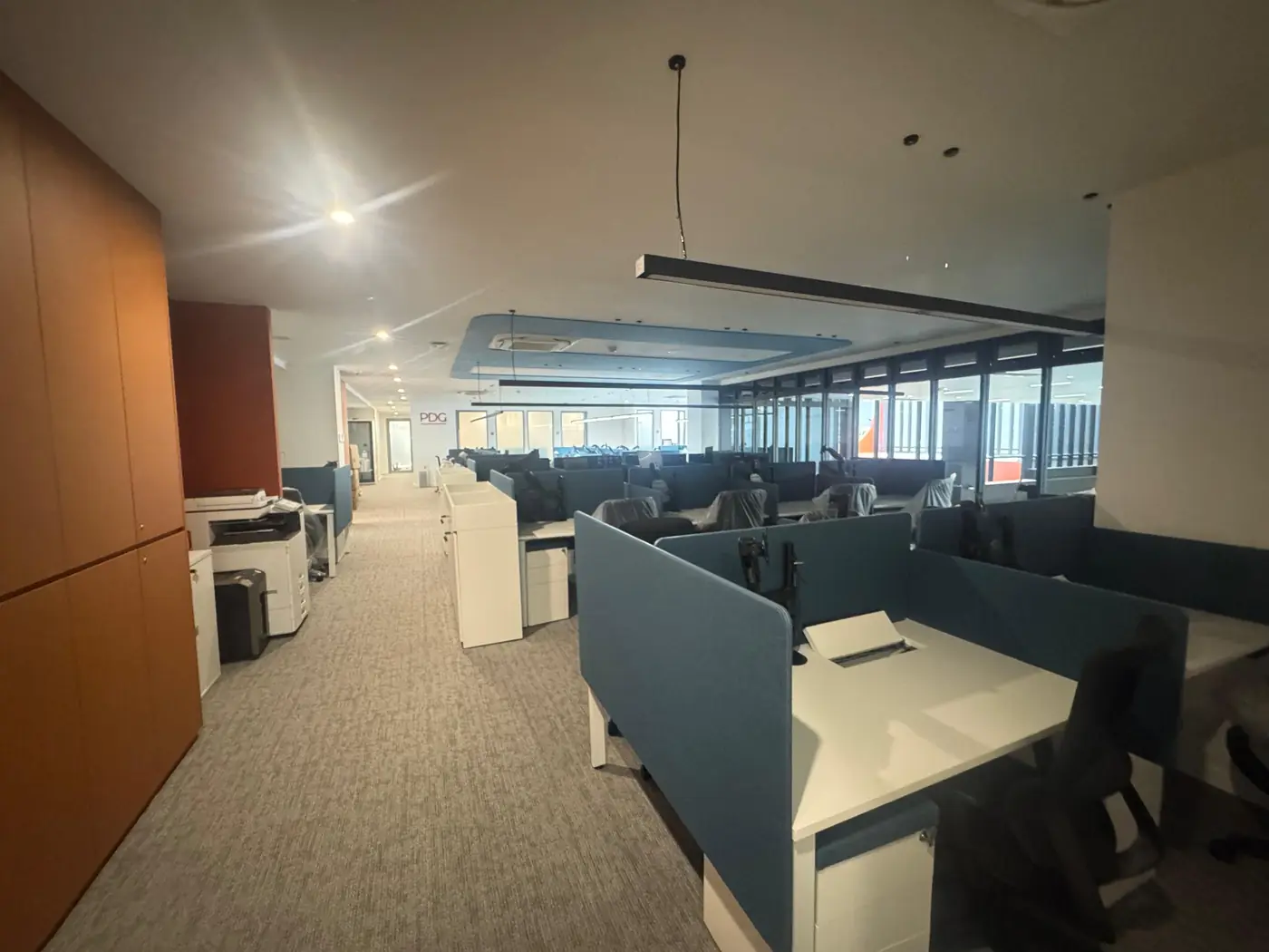 Open-plan office fit-out with workstations and pendant lighting